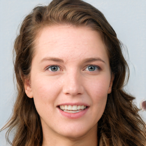 Joyful white young-adult female with long  brown hair and blue eyes