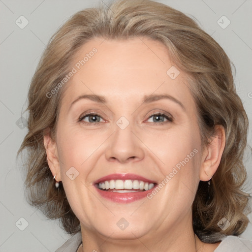 Joyful white adult female with medium  brown hair and blue eyes