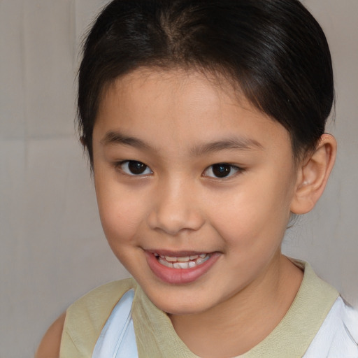 Joyful white child female with short  brown hair and brown eyes