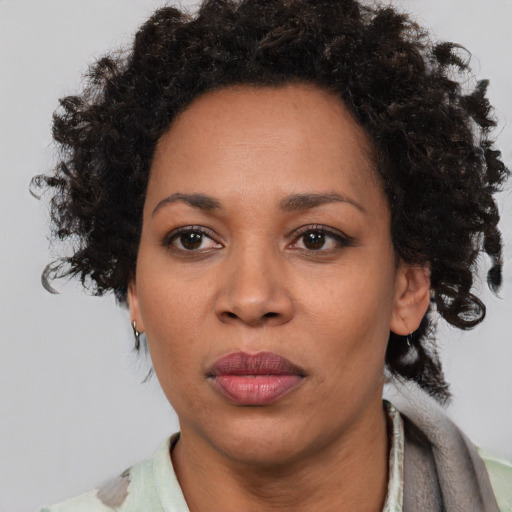 Joyful black adult female with short  brown hair and brown eyes