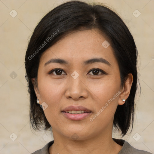 Joyful latino adult female with medium  brown hair and brown eyes