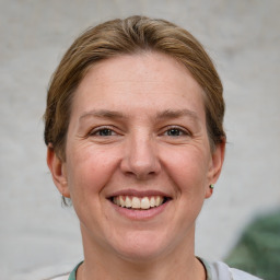 Joyful white adult female with short  brown hair and grey eyes