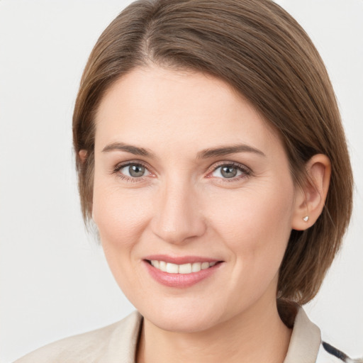 Joyful white young-adult female with medium  brown hair and grey eyes