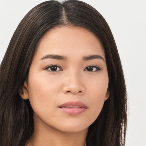 Joyful asian young-adult female with long  brown hair and brown eyes