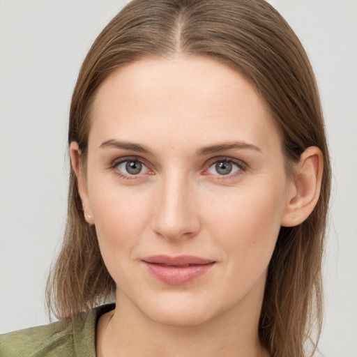 Joyful white young-adult female with long  brown hair and grey eyes