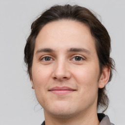 Joyful white young-adult male with medium  brown hair and brown eyes