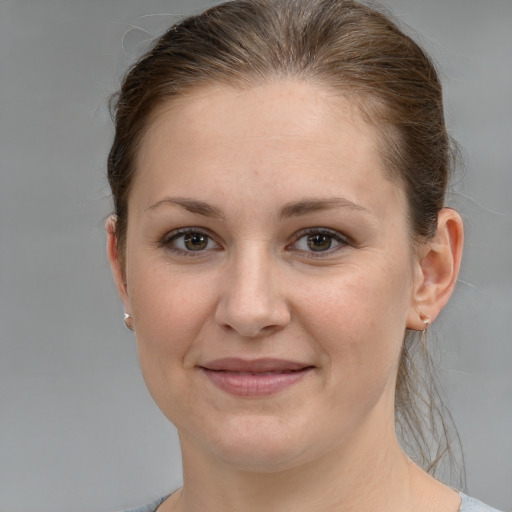 Joyful white young-adult female with medium  brown hair and grey eyes