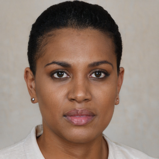 Joyful black young-adult female with short  brown hair and brown eyes