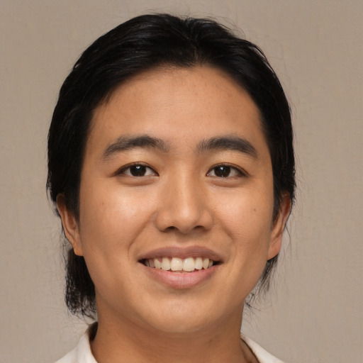 Joyful asian young-adult male with medium  black hair and brown eyes