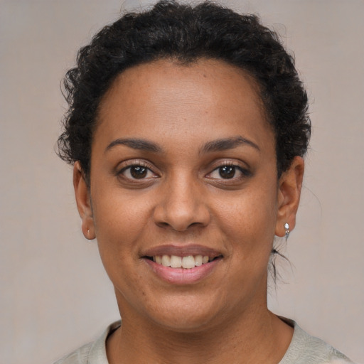 Joyful latino young-adult female with short  brown hair and brown eyes
