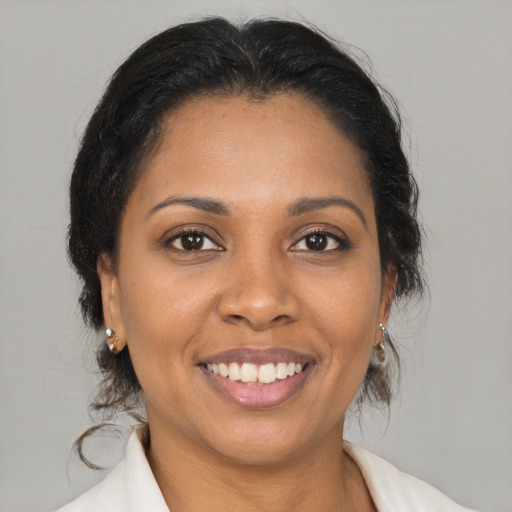 Joyful latino young-adult female with medium  brown hair and brown eyes