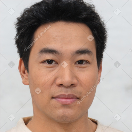 Joyful asian young-adult male with short  brown hair and brown eyes