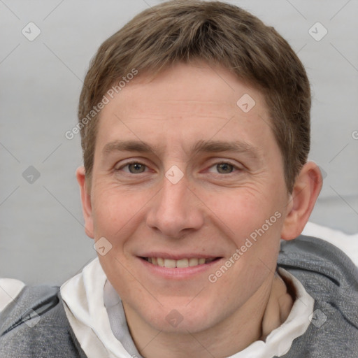 Joyful white adult male with short  brown hair and grey eyes