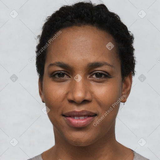 Joyful black young-adult female with short  black hair and brown eyes