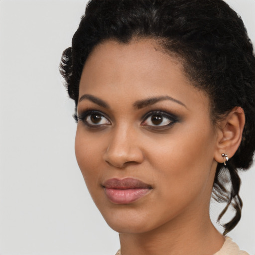 Joyful latino young-adult female with short  black hair and brown eyes