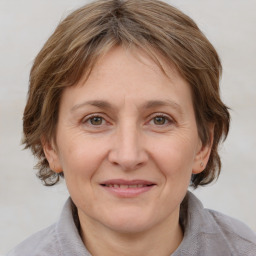 Joyful white adult female with medium  brown hair and grey eyes