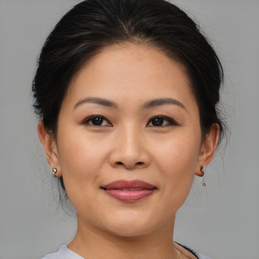 Joyful asian young-adult female with medium  brown hair and brown eyes