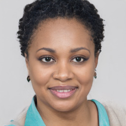 Joyful black young-adult female with short  brown hair and brown eyes