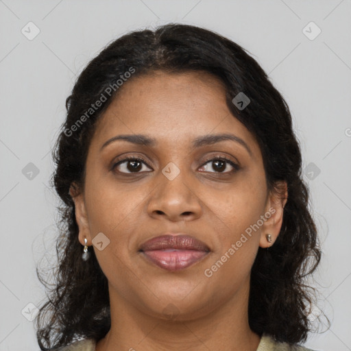 Joyful black adult female with medium  brown hair and brown eyes