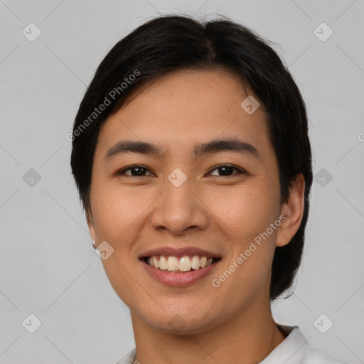 Joyful asian young-adult female with short  brown hair and brown eyes