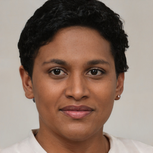 Joyful latino young-adult female with short  brown hair and brown eyes