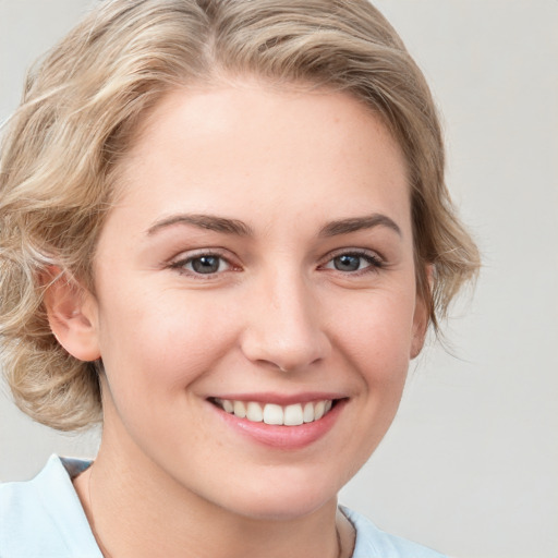 Joyful white young-adult female with medium  brown hair and blue eyes