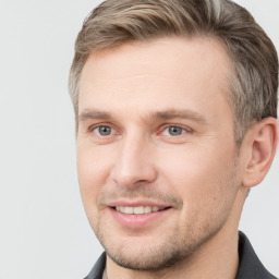 Joyful white adult male with short  brown hair and grey eyes