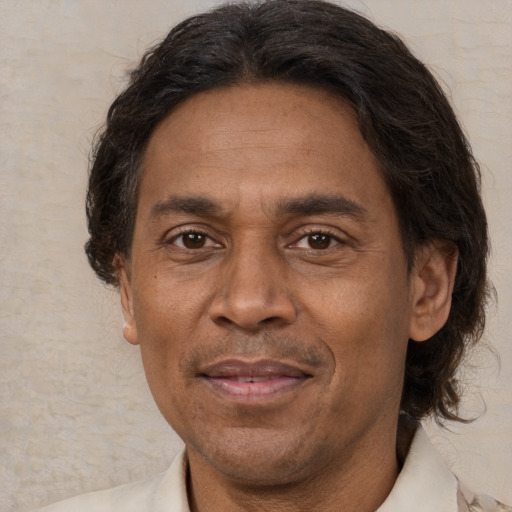 Joyful latino adult male with short  brown hair and brown eyes