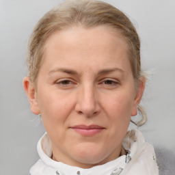 Joyful white adult female with medium  brown hair and blue eyes