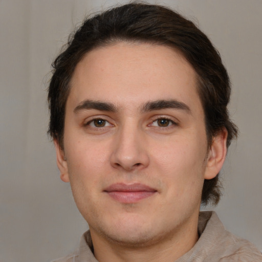 Joyful white young-adult male with short  brown hair and brown eyes