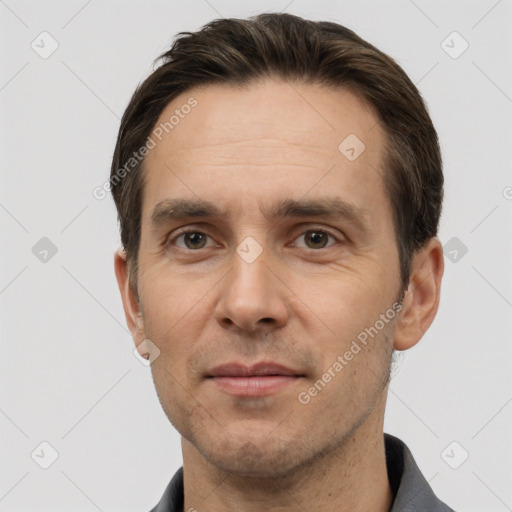 Joyful white adult male with short  brown hair and brown eyes