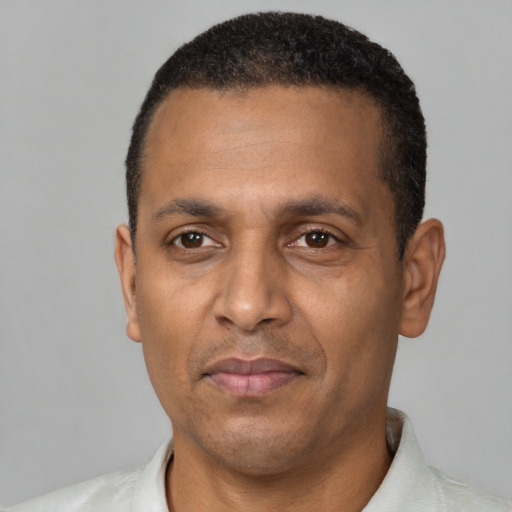 Joyful black adult male with short  black hair and brown eyes