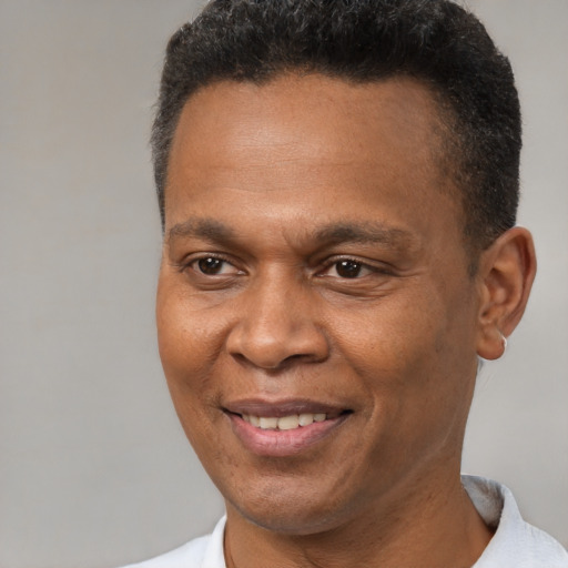 Joyful latino adult male with short  brown hair and brown eyes