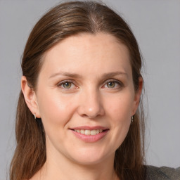 Joyful white young-adult female with medium  brown hair and grey eyes