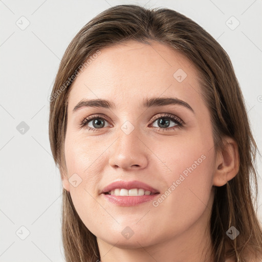 Joyful white young-adult female with long  brown hair and grey eyes