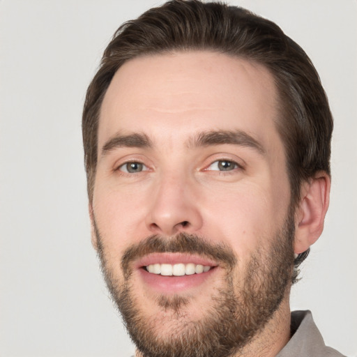 Joyful white young-adult male with short  brown hair and brown eyes