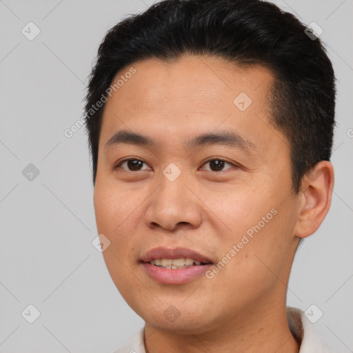 Joyful asian young-adult male with short  brown hair and brown eyes