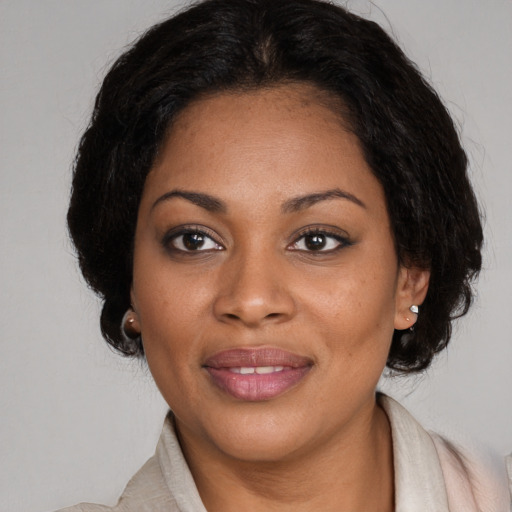Joyful black adult female with medium  brown hair and brown eyes