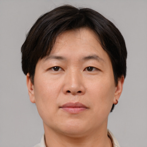 Neutral asian adult male with short  brown hair and brown eyes
