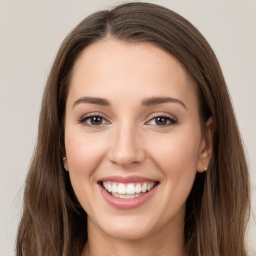 Joyful white young-adult female with long  brown hair and grey eyes