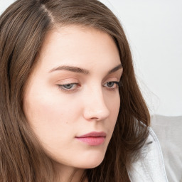 Neutral white young-adult female with long  brown hair and grey eyes