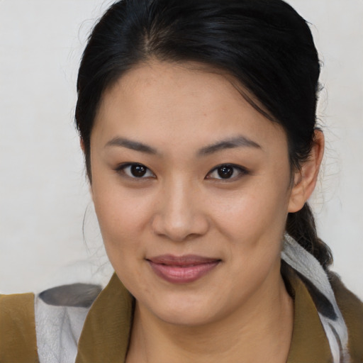 Joyful asian young-adult female with medium  brown hair and brown eyes