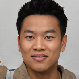 Joyful asian young-adult male with short  black hair and brown eyes