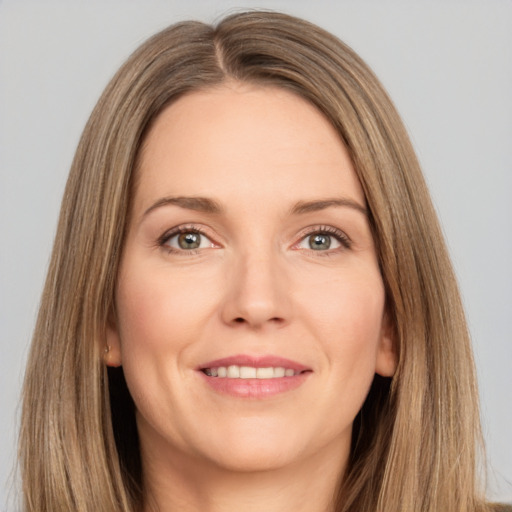 Joyful white adult female with long  brown hair and brown eyes