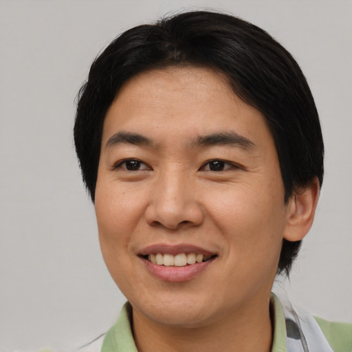 Joyful asian young-adult female with short  brown hair and brown eyes