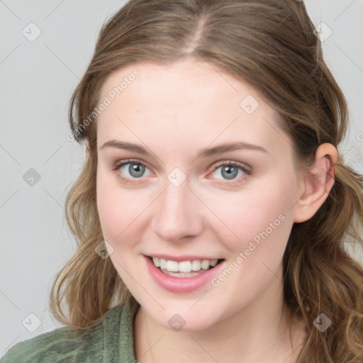 Joyful white young-adult female with long  brown hair and blue eyes