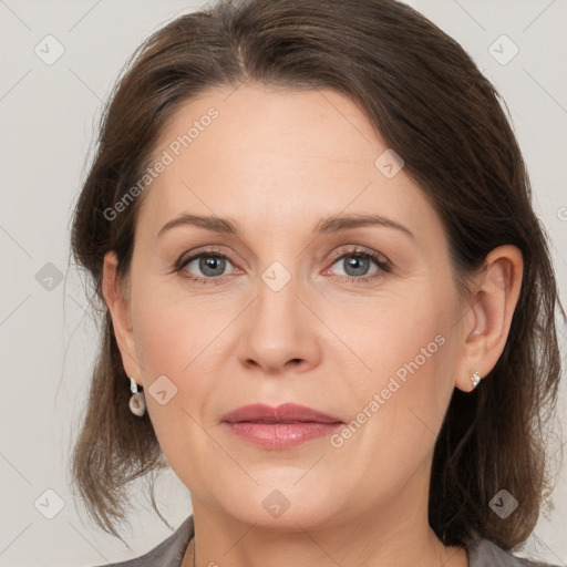 Joyful white adult female with medium  brown hair and grey eyes