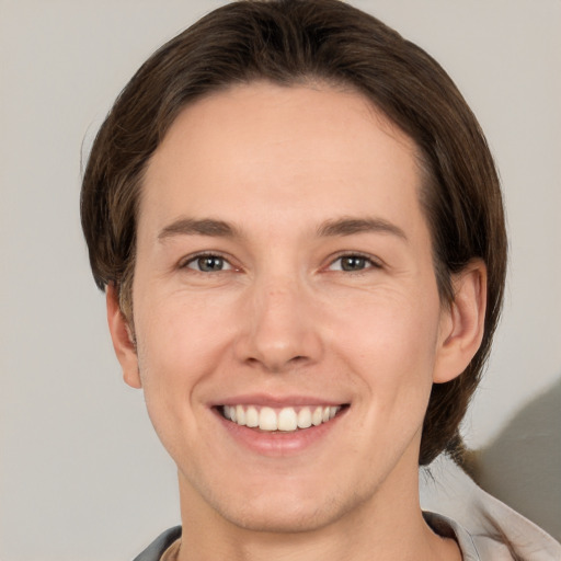 Joyful white young-adult female with short  brown hair and brown eyes