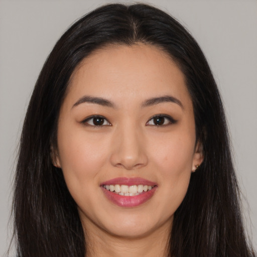 Joyful asian young-adult female with long  brown hair and brown eyes