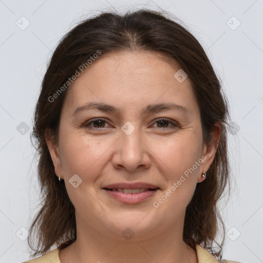 Joyful white adult female with medium  brown hair and brown eyes